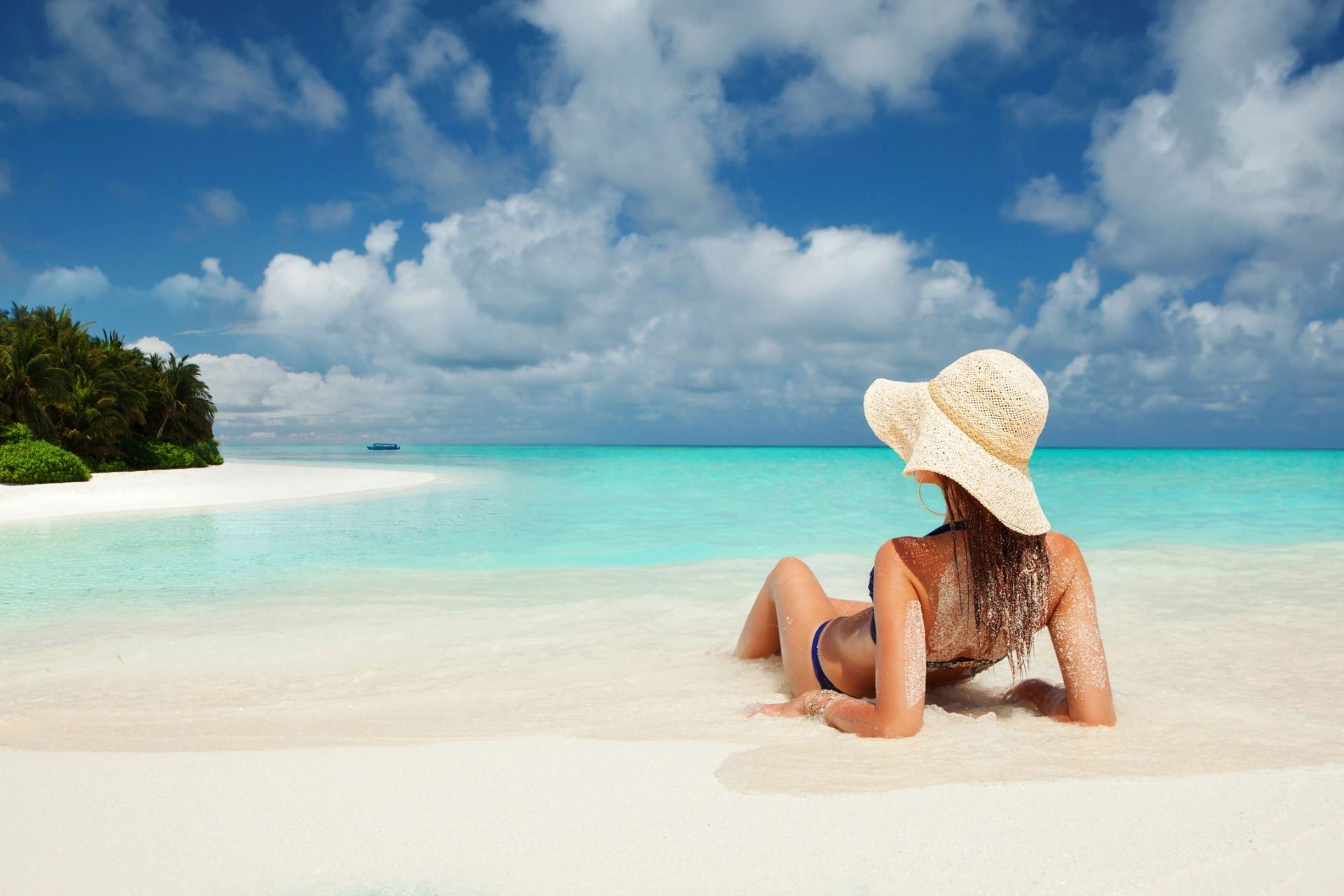A serene image of a person relaxing at the edge of the ocean, symbolizing peace and balance achieved through healthy boundaries.
