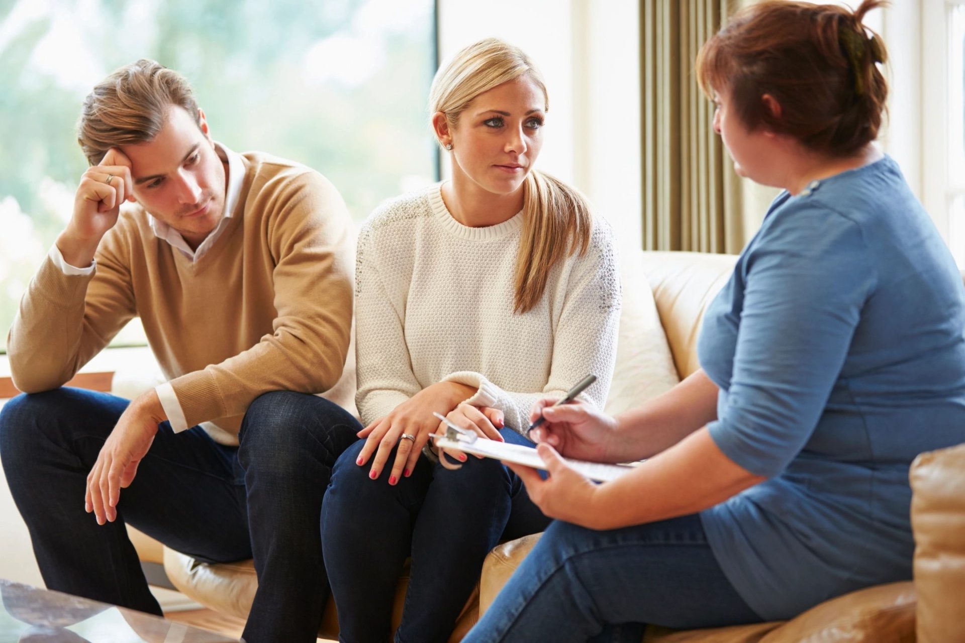 A happy couple holding hands and smiling after successful couples counselling.