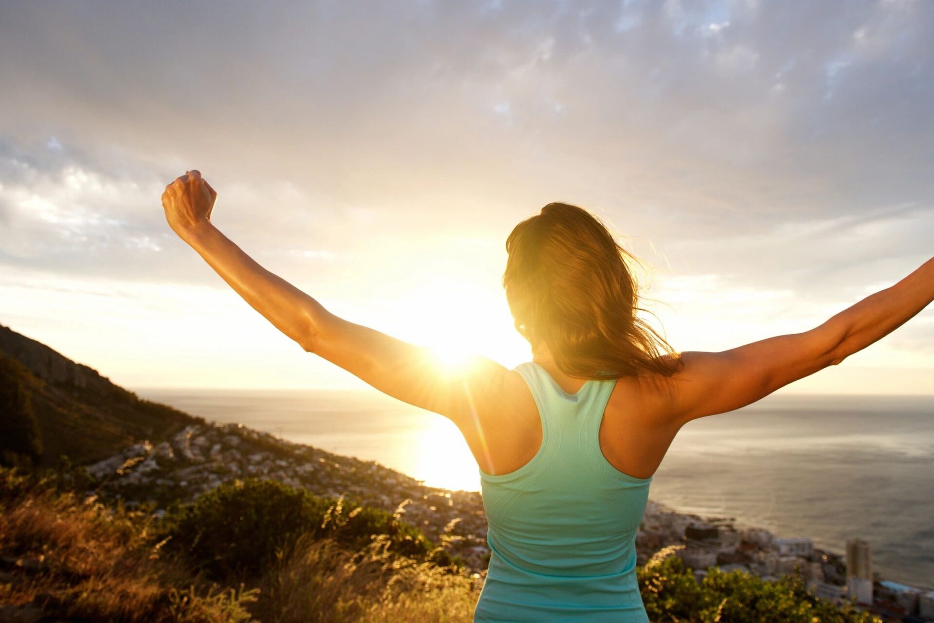 Woman walking outdoors on a peaceful path, demonstrating how gentle movement can reduce stress, restore energy, and support overall wellbeing.