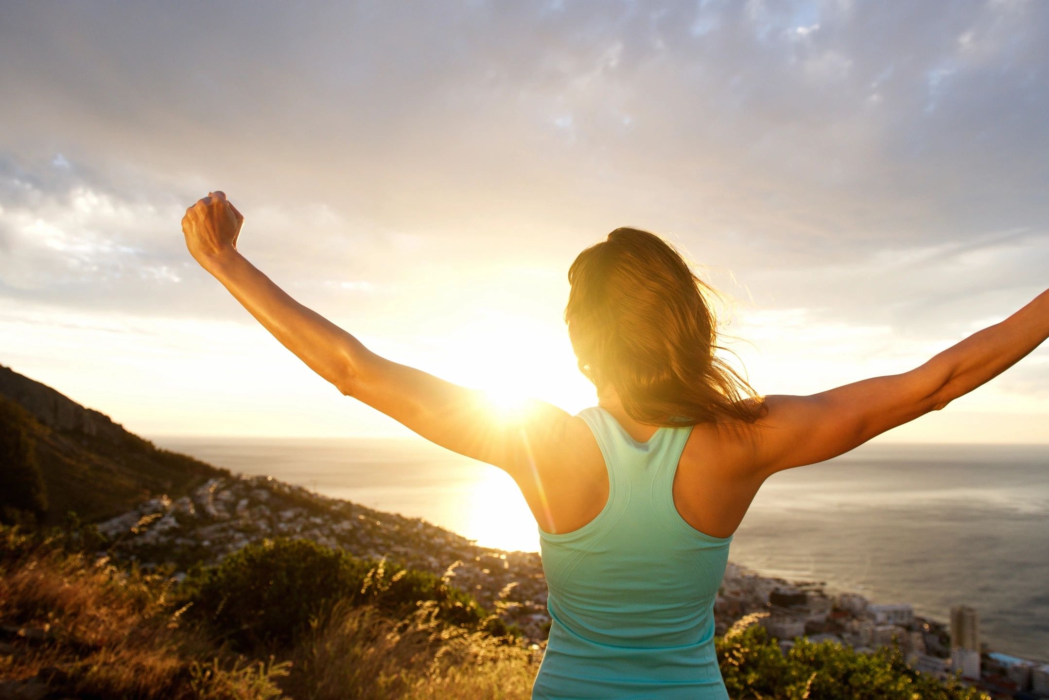 Woman walking outdoors on a peaceful path, demonstrating how gentle movement can reduce stress, restore energy, and support overall wellbeing.