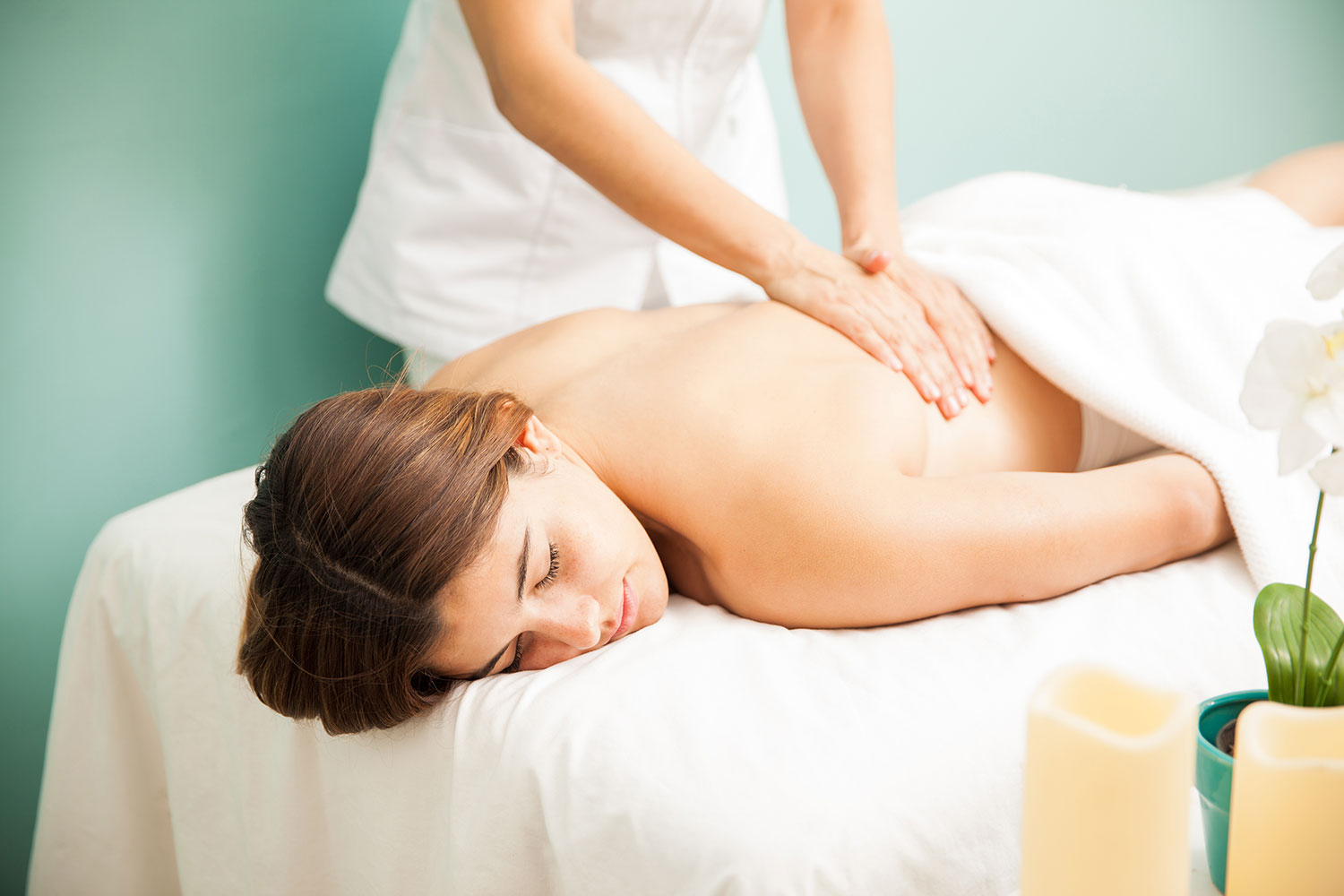 A woman receiving a relaxing back massage at a spa